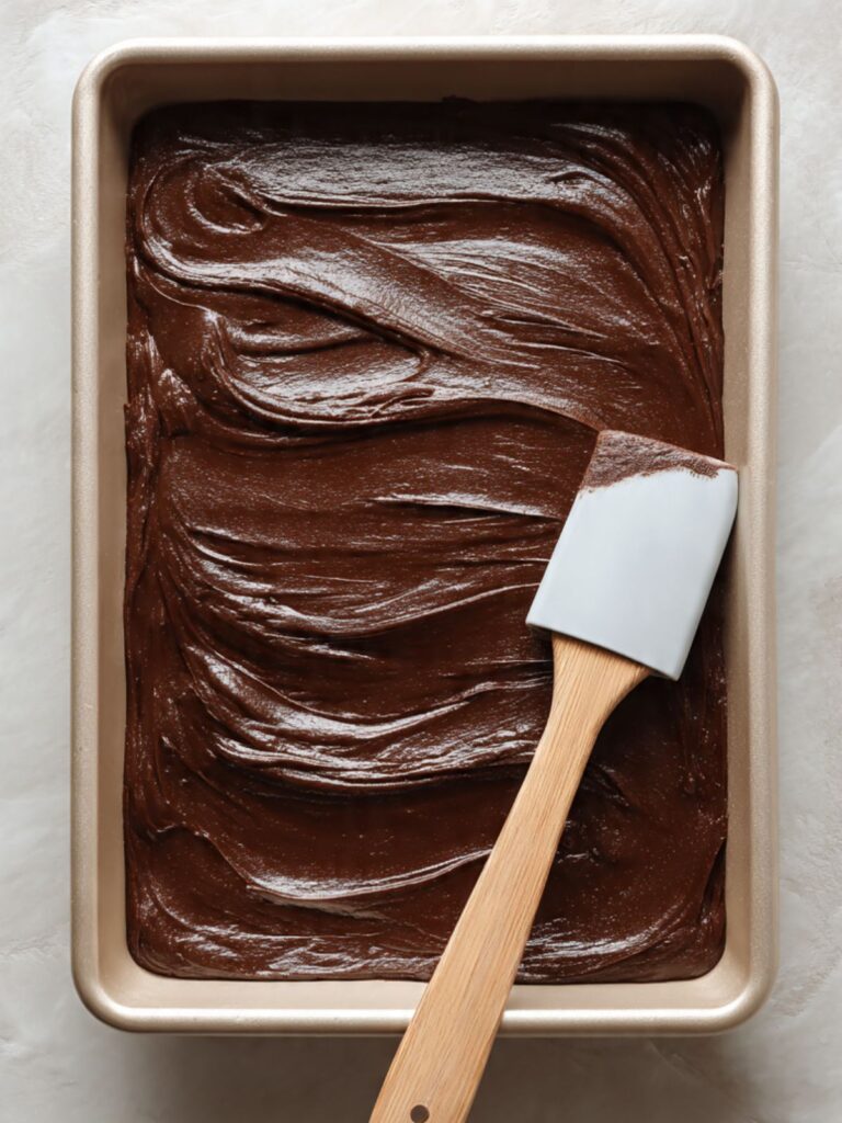 texas sheet cake thin dark chocolate batter spread flat in greased half sheet pan ready to bake